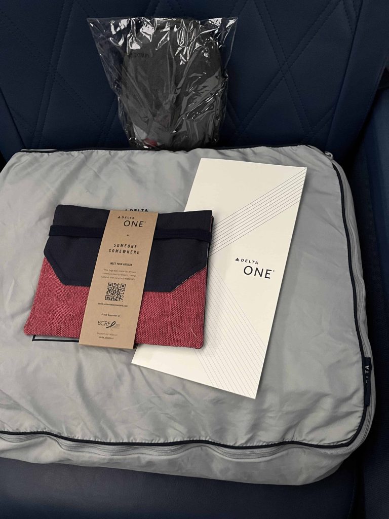 Amenity Kit, Bedding, Slippers And Menu when boarding Delta One