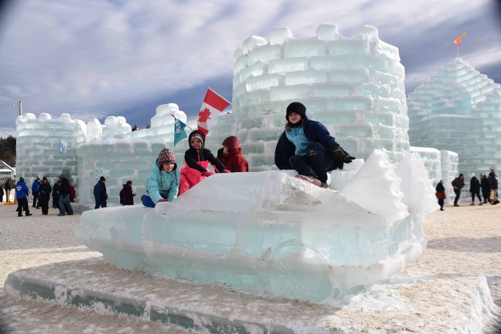 Day time photo of kids playing at the ice castle
