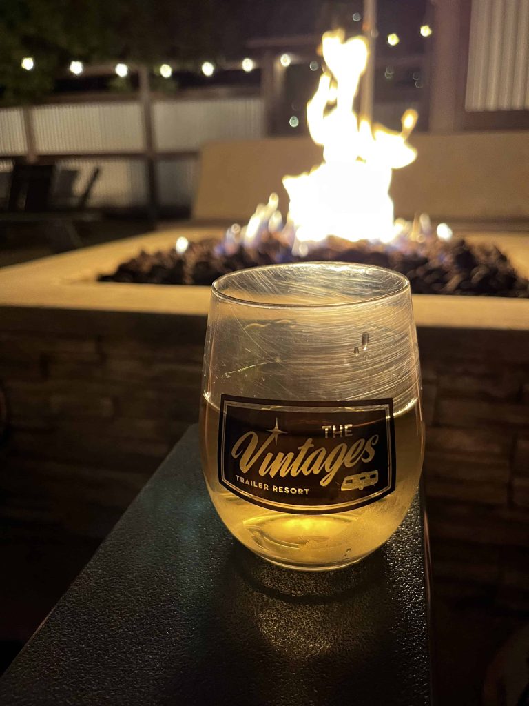 Vintages Trailer Resort wine glass with fire pit in background