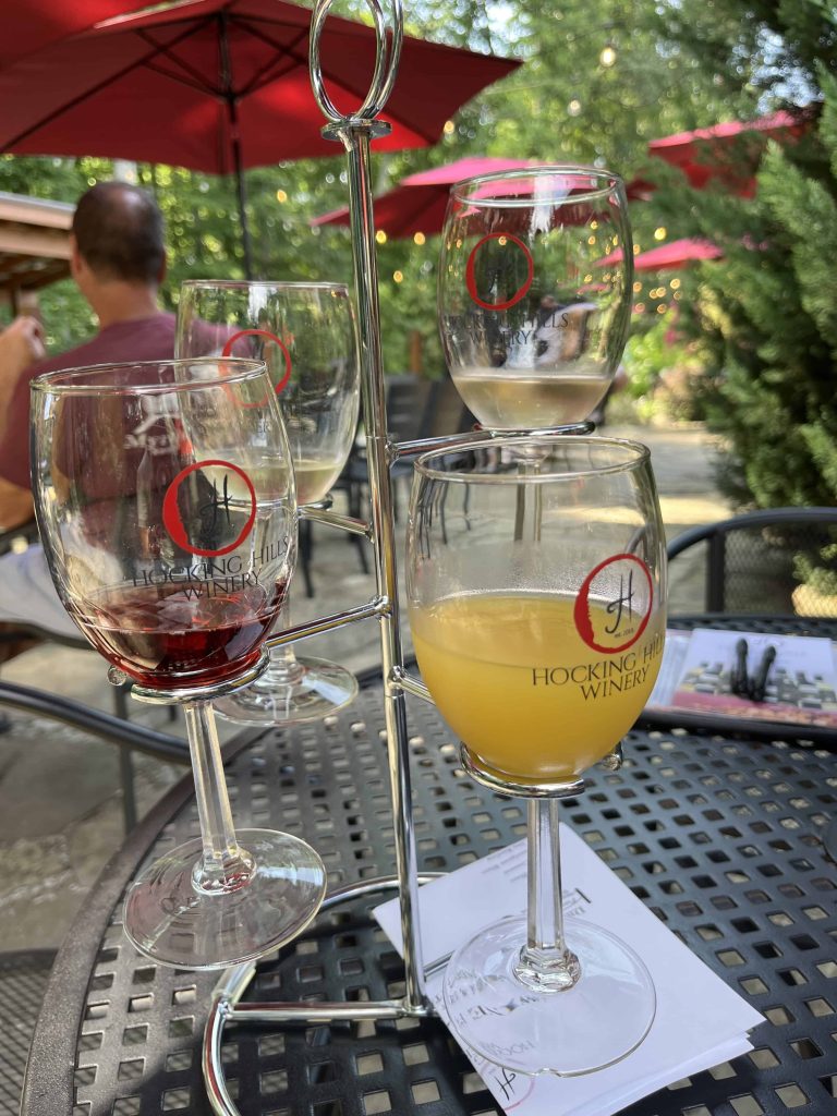 Wine tasting glasses on a table on patio at winery