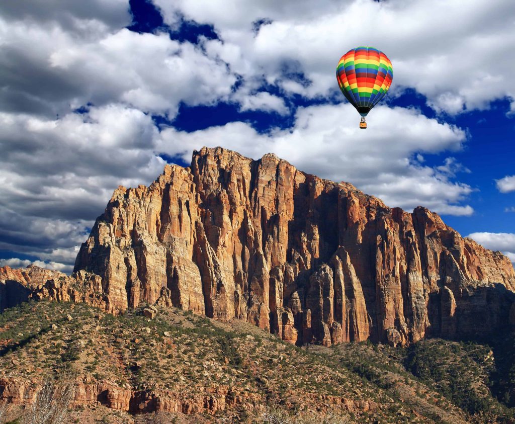Colorful hot air balloon soaring over Zion National Park