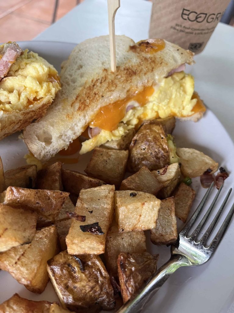 Breakfast sandwich with homefries on a plate