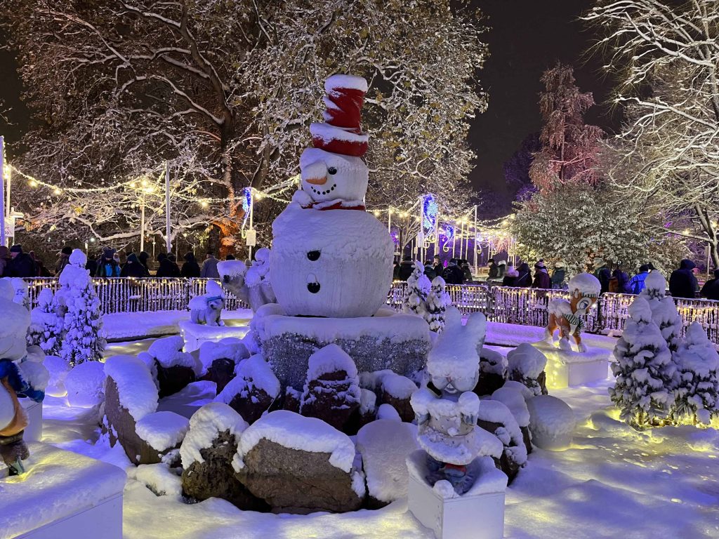 Snowman and lights on snowy night at Vienna Christmas Markets