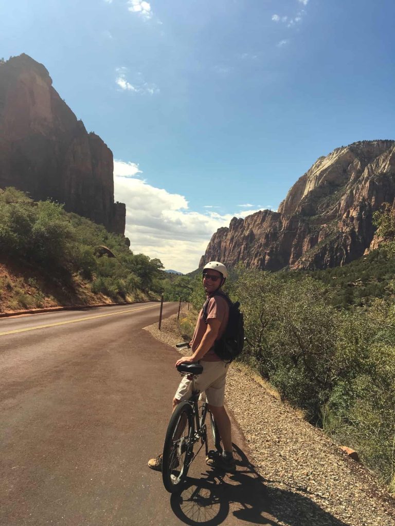 Man on bike along road in Zion Park