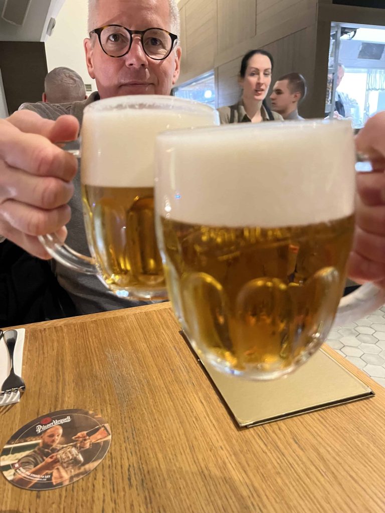 Toasting with Czech beer in a restaurant in Prague