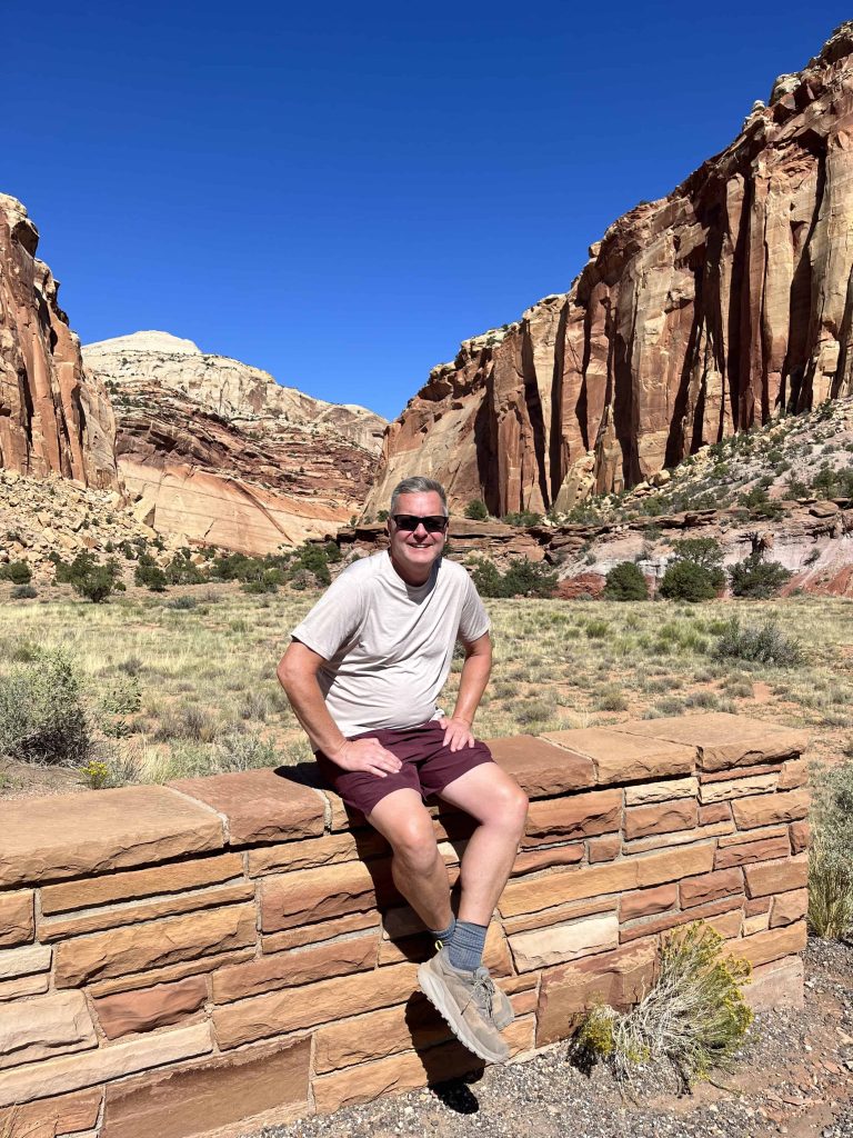Me sitting on a wall at the end of the Scenic Drive in Capitol Reef.
