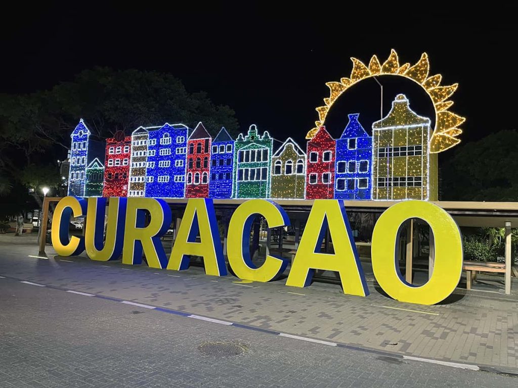 A lit sign in downtown Willemstad, Curacao at night.