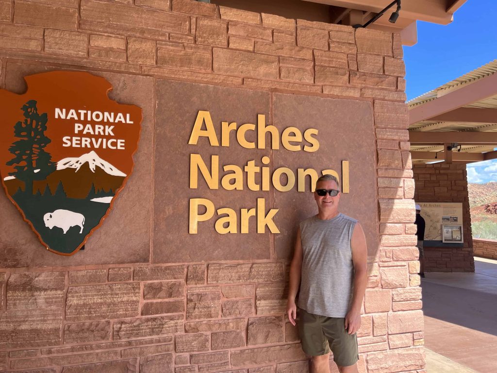 Me standing by the Arches National Park sign.