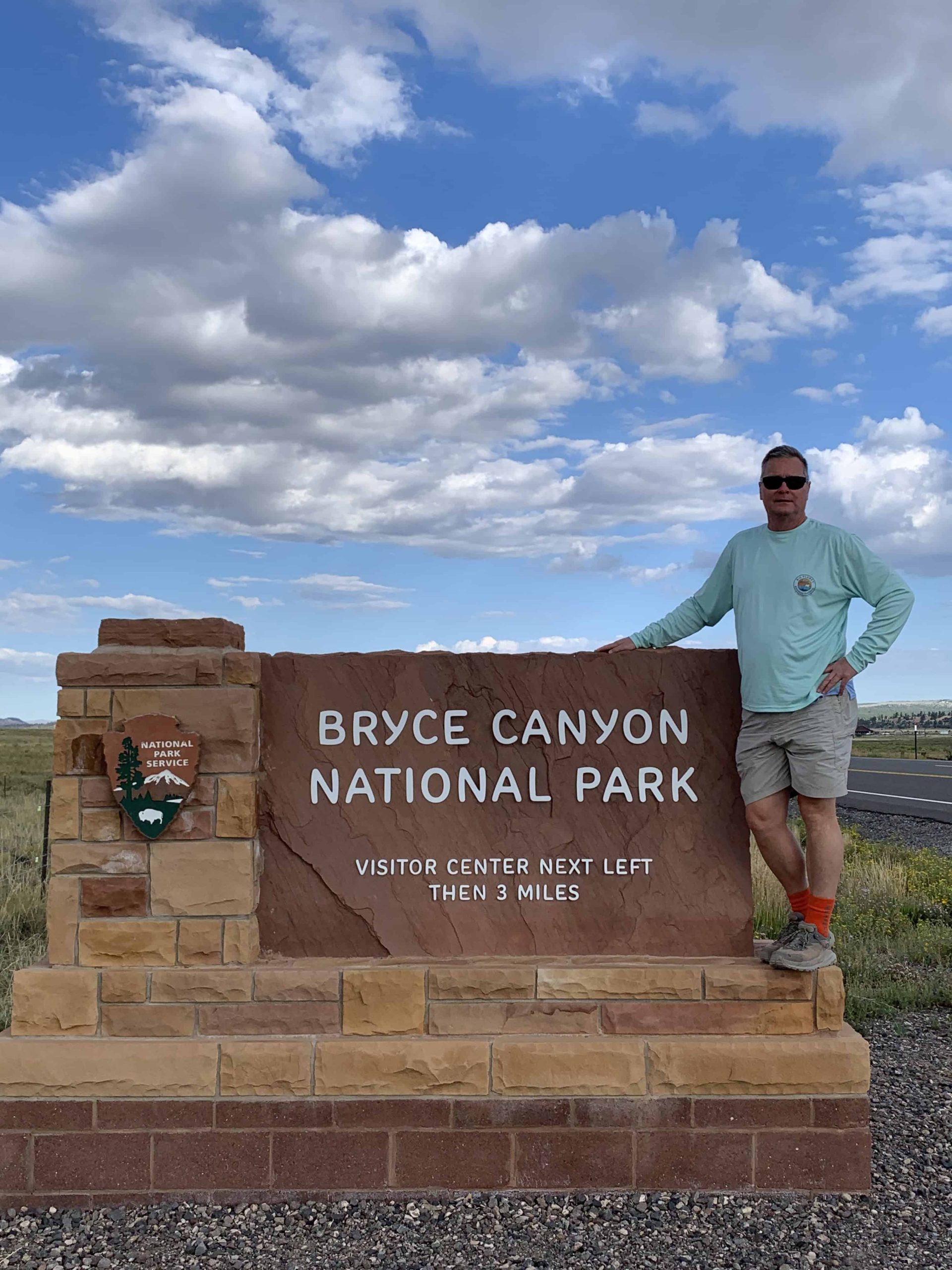 Tim standing by the sign to Bryce Canyon National Park.